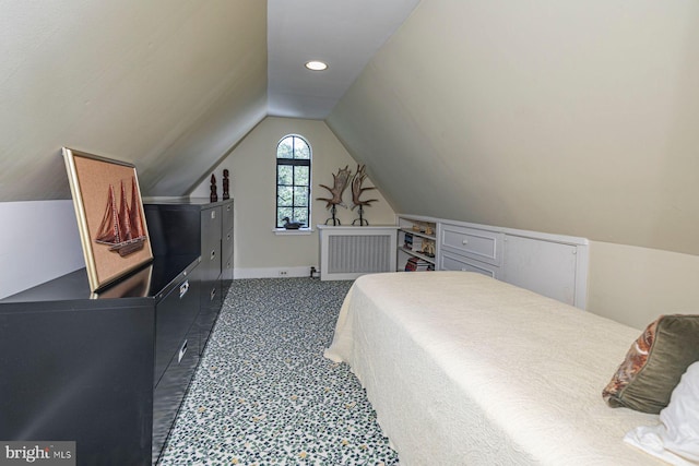 bedroom featuring lofted ceiling and dark colored carpet