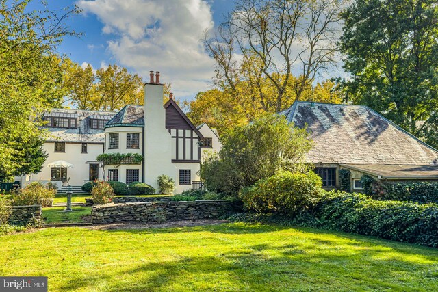 view of side of home with a yard