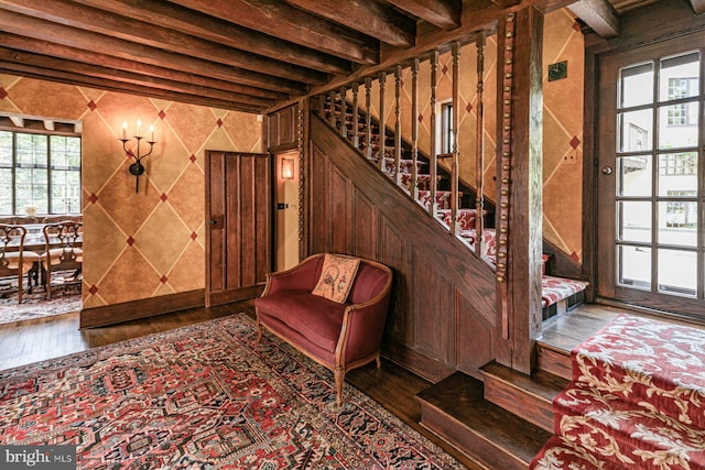 interior space with beamed ceiling and hardwood / wood-style flooring