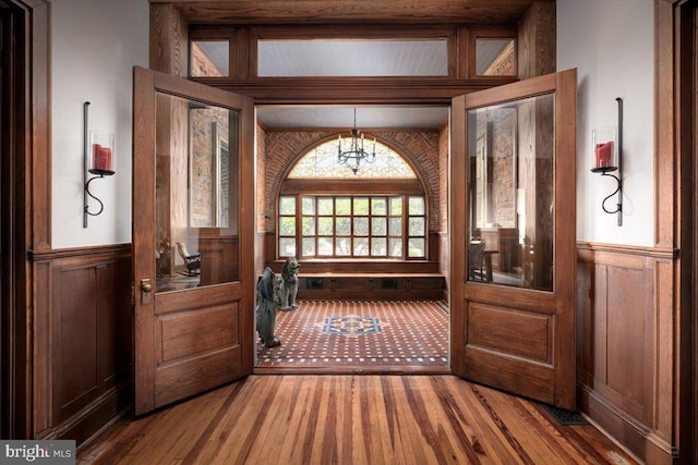 doorway featuring hardwood / wood-style flooring and an inviting chandelier