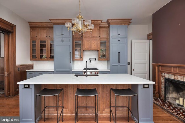 kitchen featuring gray cabinetry, decorative light fixtures, dark hardwood / wood-style floors, a large island, and a chandelier