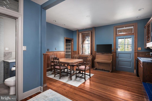 dining space with dark hardwood / wood-style floors and sink