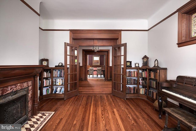 sitting room featuring an inviting chandelier, dark hardwood / wood-style floors, and french doors