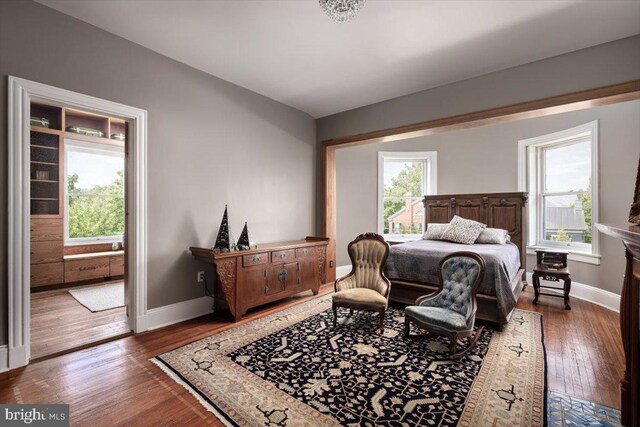 bedroom with dark hardwood / wood-style floors and ceiling fan