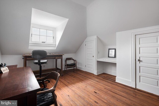 additional living space featuring hardwood / wood-style flooring and lofted ceiling