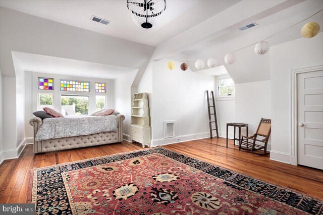 sitting room featuring vaulted ceiling and hardwood / wood-style flooring