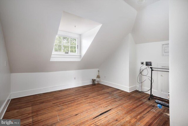 bathroom featuring shower / bath combo with shower curtain, toilet, lofted ceiling, and hardwood / wood-style flooring