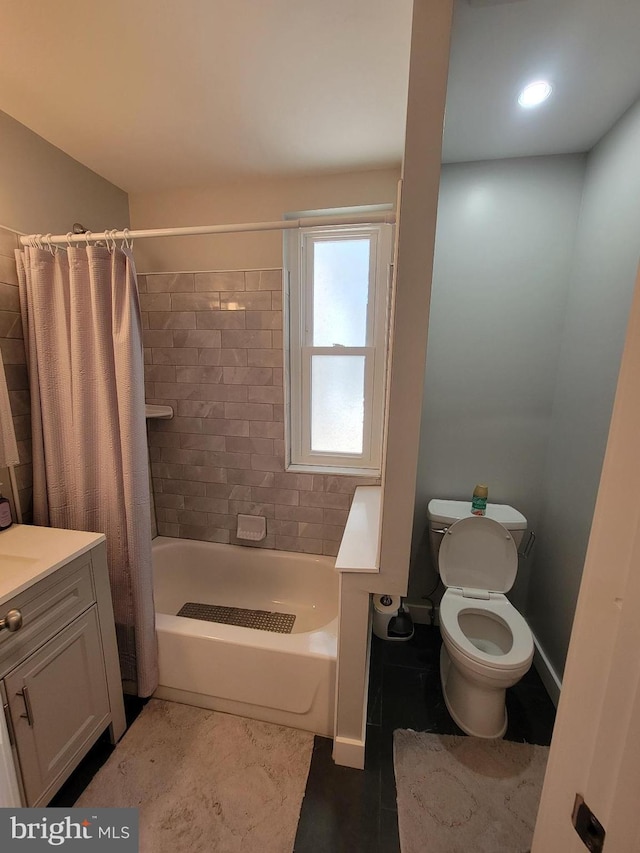 full bathroom featuring vanity, shower / bath combo, and toilet