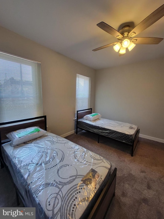 bedroom featuring dark carpet and ceiling fan