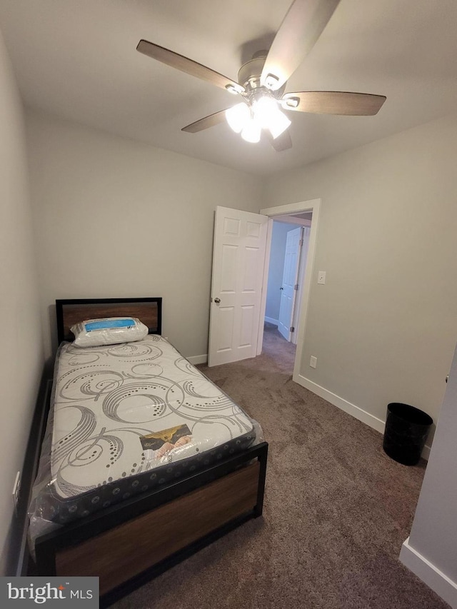 bedroom featuring ceiling fan and dark carpet