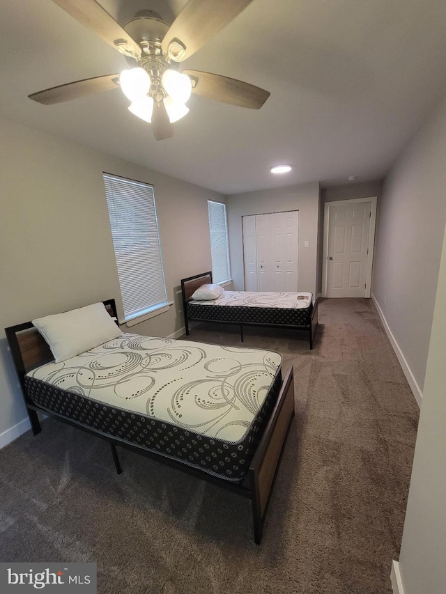 bedroom with ceiling fan, carpet floors, and a closet