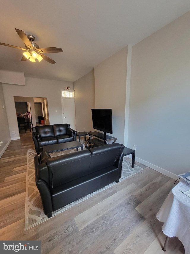 living room with ceiling fan and wood-type flooring