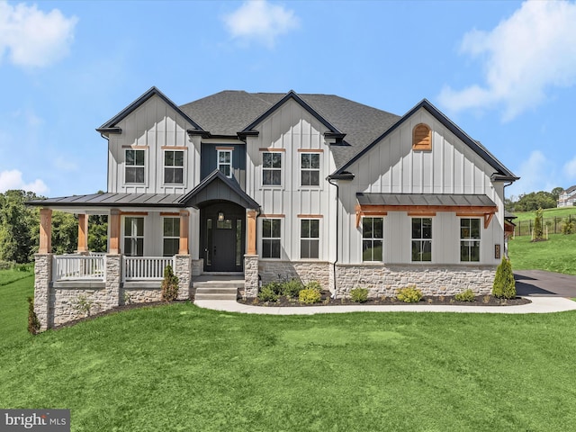 modern inspired farmhouse featuring covered porch and a front lawn