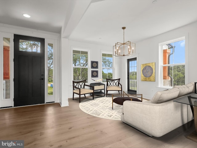 entrance foyer with hardwood / wood-style floors and a notable chandelier