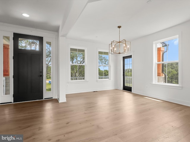 foyer featuring a chandelier and light hardwood / wood-style flooring