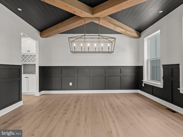 unfurnished dining area with a chandelier, lofted ceiling with beams, light hardwood / wood-style flooring, and wooden ceiling