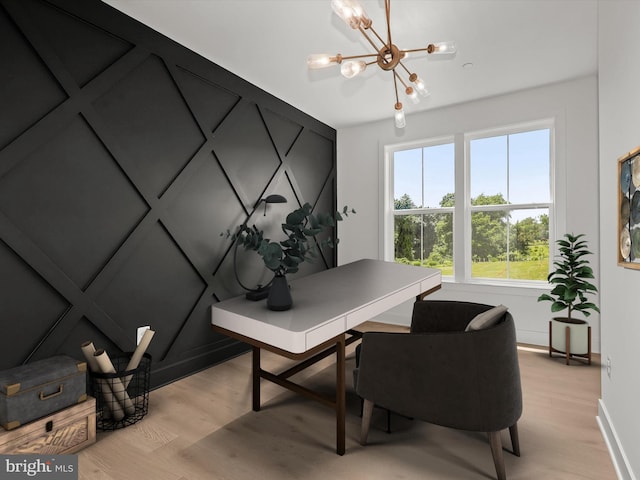 office space featuring an inviting chandelier and light hardwood / wood-style flooring