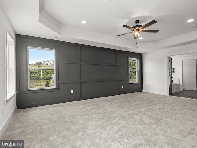 interior space featuring a raised ceiling, ceiling fan, and ornamental molding