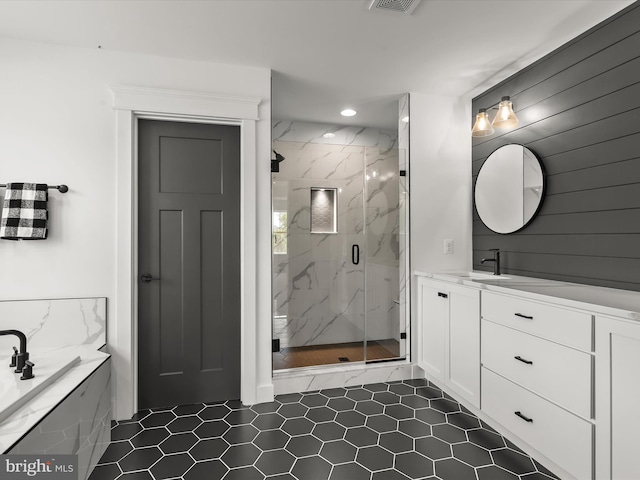 bathroom with vanity and a shower with shower door