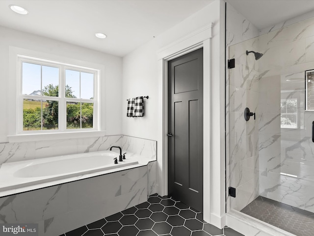 bathroom featuring separate shower and tub