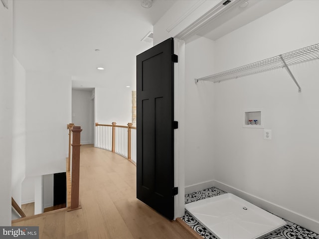 washroom featuring hookup for a washing machine and hardwood / wood-style floors