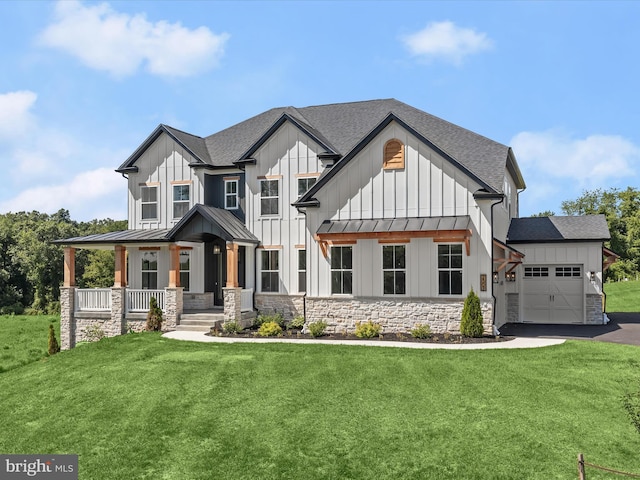 modern inspired farmhouse with a front lawn, a porch, and a garage