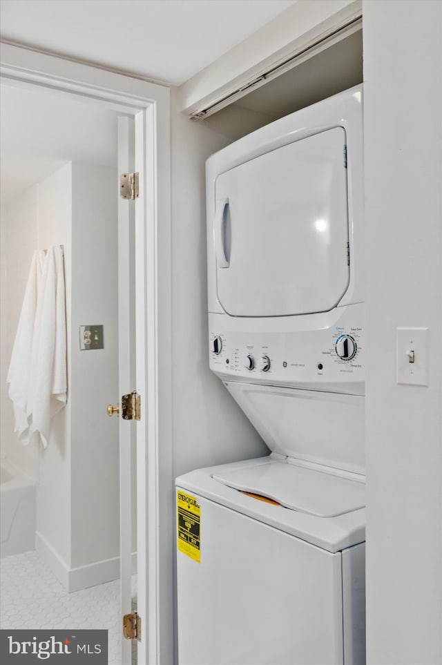 laundry area featuring stacked washer / dryer