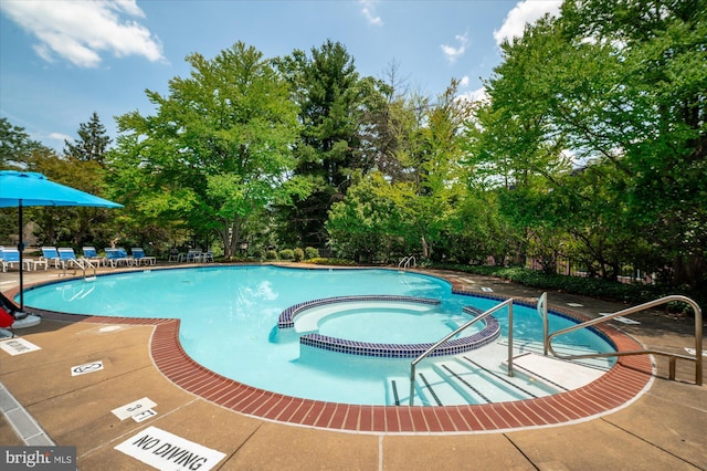 view of pool featuring a hot tub