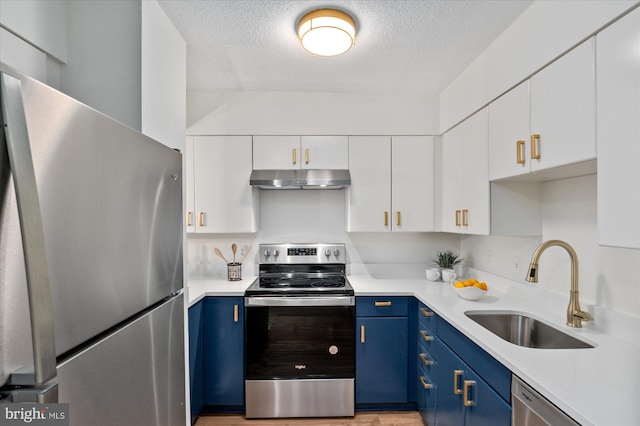 kitchen with white cabinets, blue cabinets, sink, a textured ceiling, and appliances with stainless steel finishes