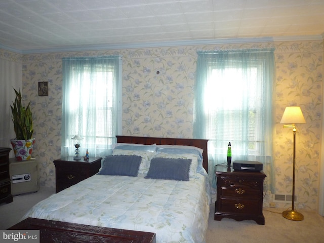 bedroom featuring multiple windows, crown molding, and carpet floors