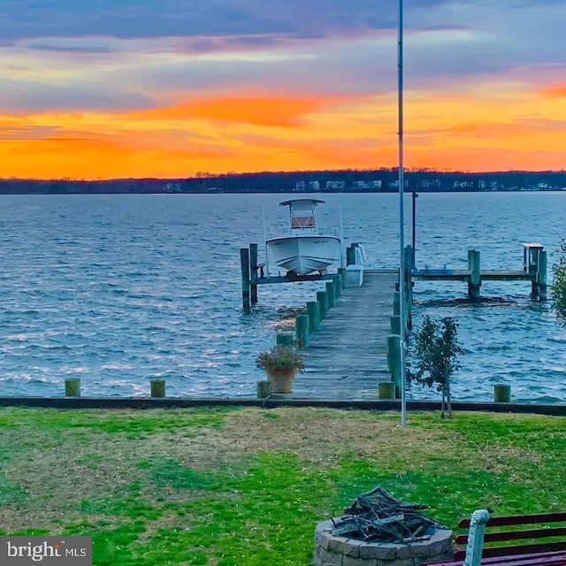 dock area with a water view and an outdoor fire pit