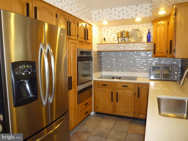 kitchen featuring light tile patterned flooring, stainless steel appliances, and sink