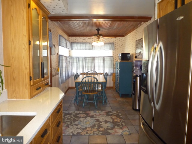 kitchen with stainless steel fridge with ice dispenser, dark tile patterned floors, ceiling fan, and wooden ceiling