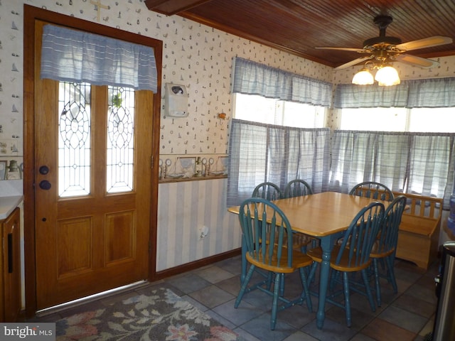 dining space with light tile patterned floors, ceiling fan, and wood ceiling