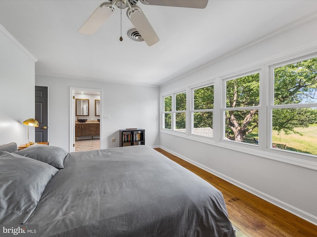 bedroom with hardwood / wood-style floors, ceiling fan, ornamental molding, and ensuite bathroom