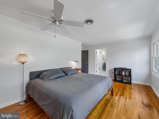 bedroom with hardwood / wood-style floors, ceiling fan, and crown molding