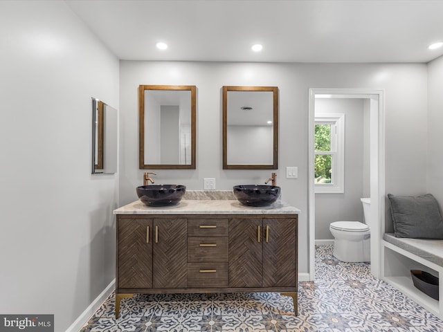 bathroom featuring tile patterned flooring, vanity, and toilet