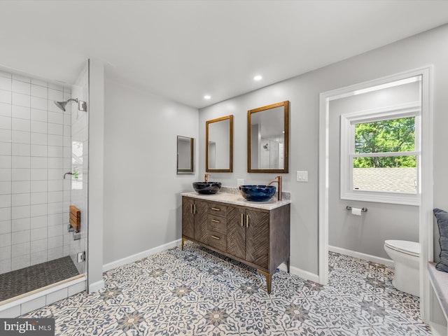 bathroom featuring vanity, toilet, and walk in shower