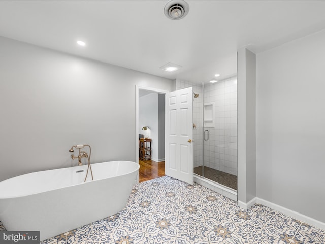 bathroom featuring plus walk in shower