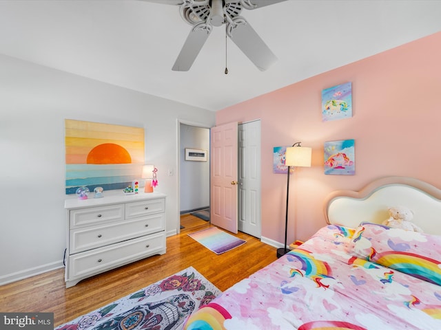 bedroom featuring ceiling fan, light hardwood / wood-style floors, and a closet