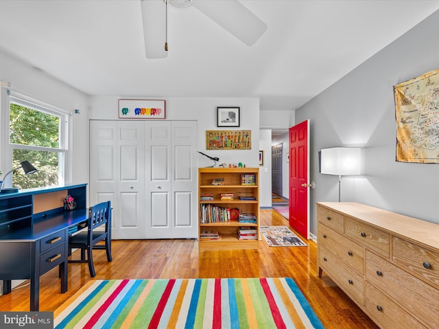 bedroom featuring wood-type flooring, a closet, and ceiling fan