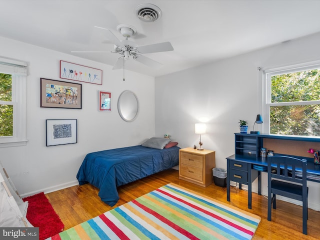 bedroom with wood-type flooring and ceiling fan