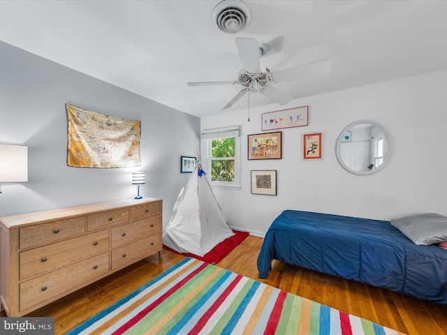 bedroom featuring ceiling fan and dark hardwood / wood-style floors