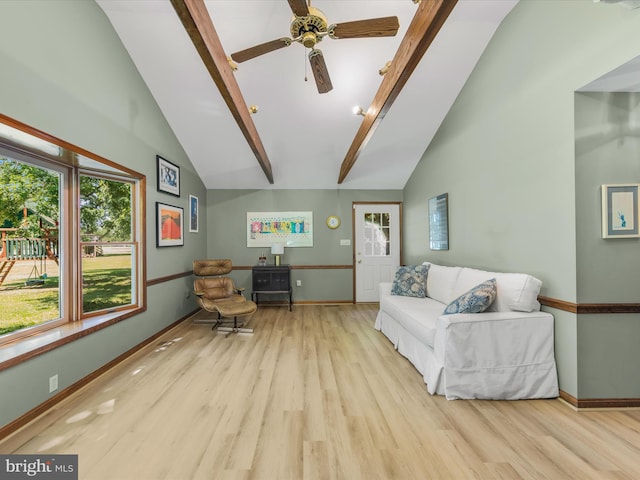 living room featuring ceiling fan, light hardwood / wood-style floors, and vaulted ceiling