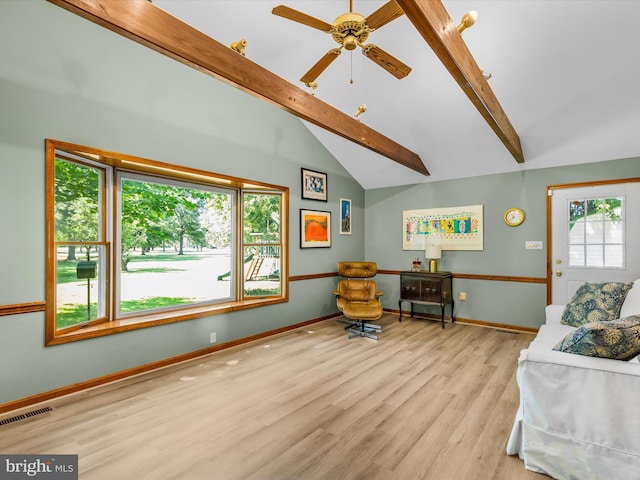 living room featuring beam ceiling, light wood-type flooring, high vaulted ceiling, and ceiling fan