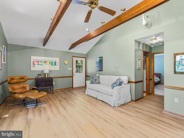 living room featuring lofted ceiling with beams, ceiling fan, and light hardwood / wood-style flooring