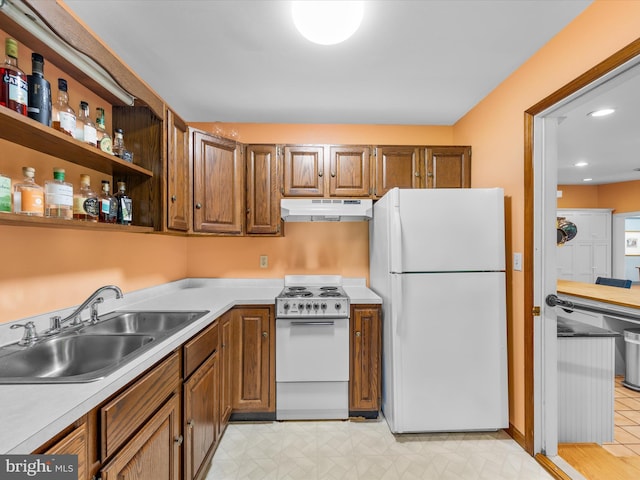 kitchen featuring white appliances and sink