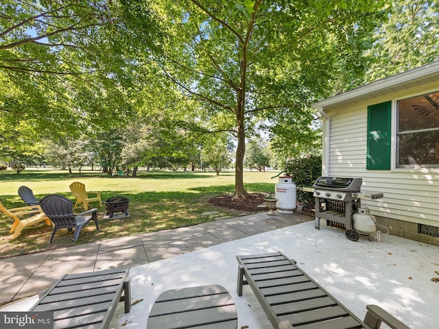 view of patio featuring an outdoor fire pit and a grill