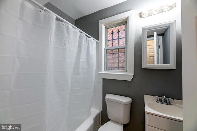 full bathroom with vanity, shower / bath combination with curtain, and toilet