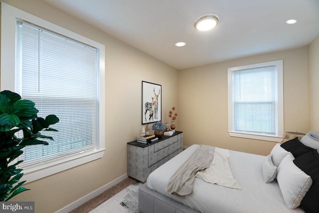 bedroom featuring carpet floors and multiple windows